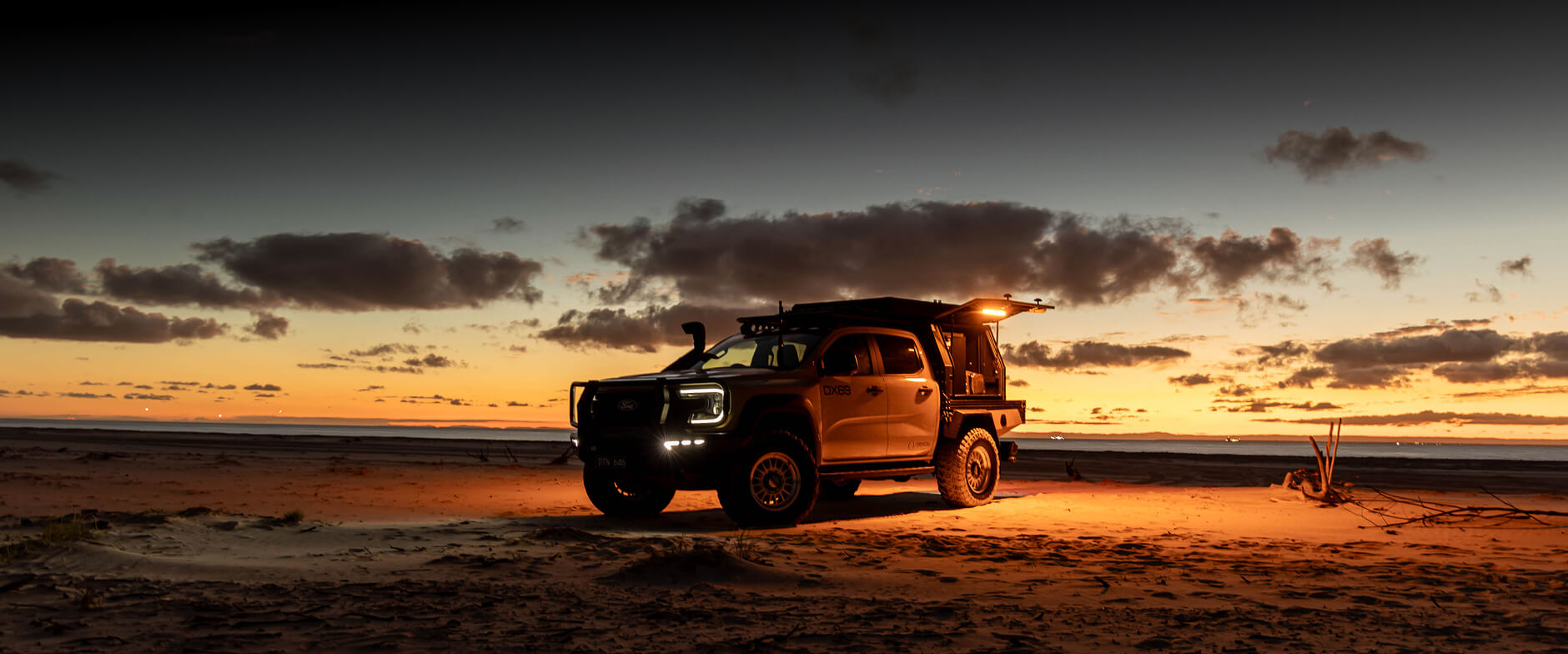 Ford Ranger Super Duty on a beach at sunset

